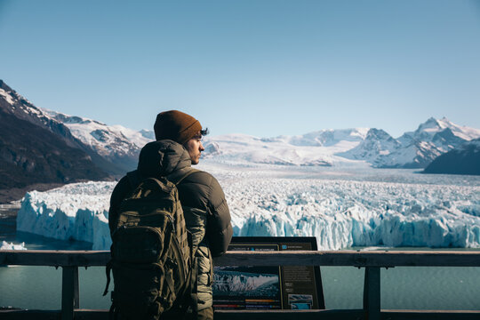 Man gazing at Perito Moreno Glacier on a sunny day