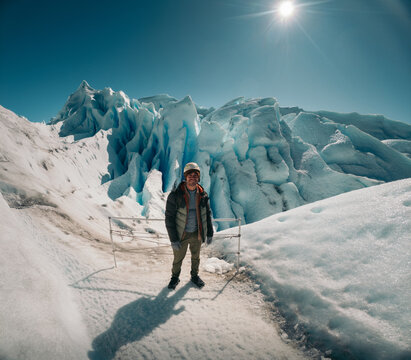 Man exploring Perito Moreno Glacier on a sunny day