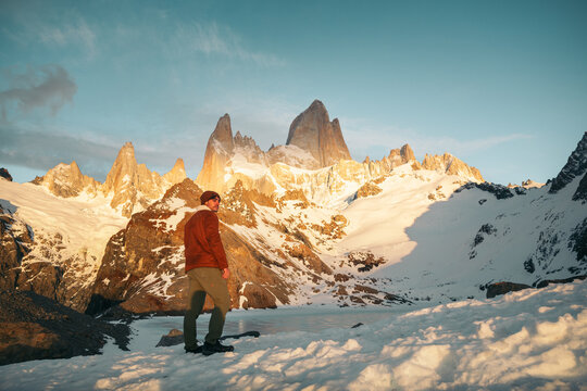 Facing the wild: explorer at sunlit Fitz Roy