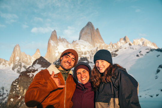 Group of friends posing before Fitz Roy peaks