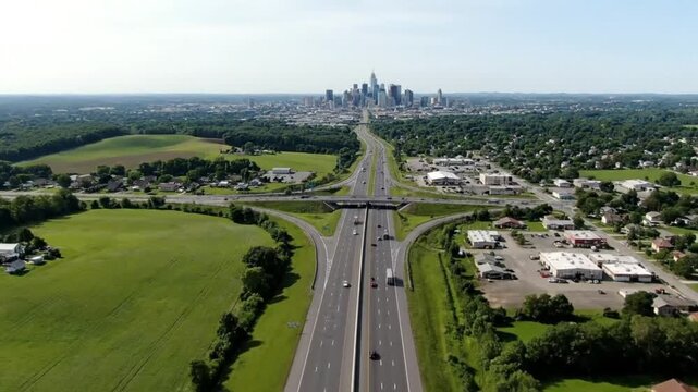 Aerial View of Highway Interchange Leading to City Skyline