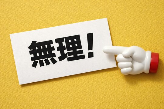 白いカードに書かれた無理という筆文字を指差すおもちゃのような白い手のひらの写真