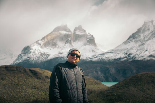 Happy adventurer against snow-covered Patagonian backdrop