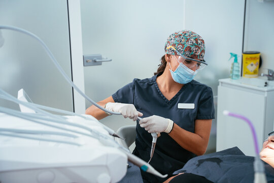 Dentist preparing dental tools for patient treatment