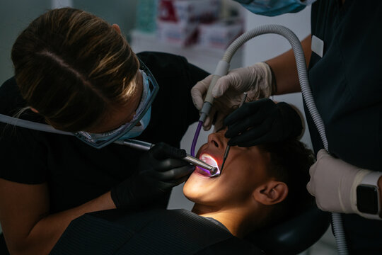 Dental professional treating patient's teeth in a clinic