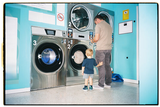 Father and Son Doing Laundry at the Laundromat