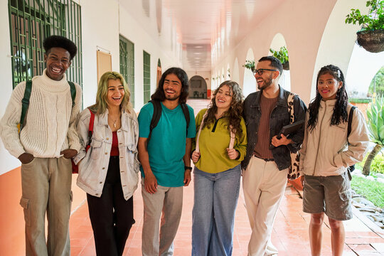 Diverse students college campus hallway laughing
