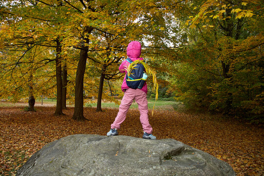 Child standing on a rock