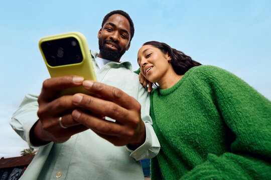 Happy couple taking selfie outdoors