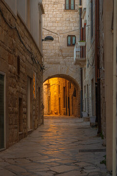 Narrow cobblestone street in the old town of Molfetta, Italy