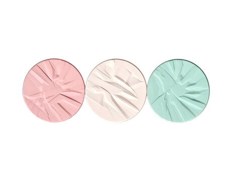 Three circular makeup compacts with textured surfaces in pink, nude, and mint green