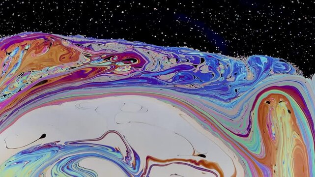 Soap bubble breaking apart in slow motion near collapse. Its fragile surface fragments, stretches and thins, revealing the final stage before bursting completely.