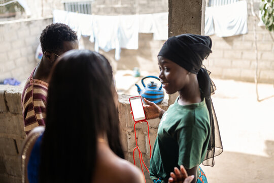 Young Senegalese people sharing smartphone content indoors