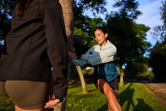 Women stretching in the park during golden hour