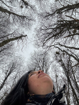 UCG Selfie Winter Trees Reach Toward the Cloudy Sky Above a Person
