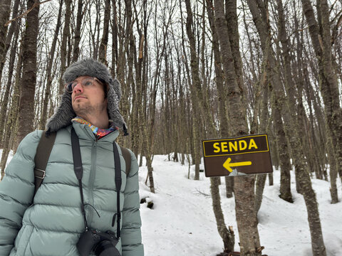 UGC Hiker Exploring Snowy Trail With Send Sign in Forest