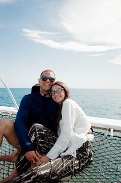 Couple Enjoying a Moment on a Boat Under the Sunny Sky