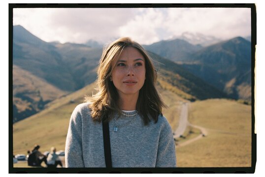 Young woman enjoying the serene mountain view on an autumn vibes