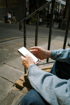 Hand holding phone with blank screen