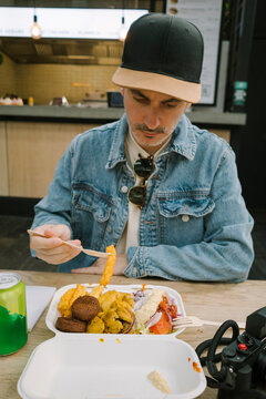 Man eating Turkish food outdoors