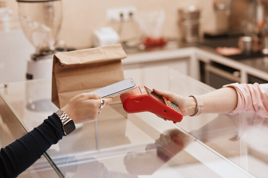 Customer using smartphone to make contactless payment