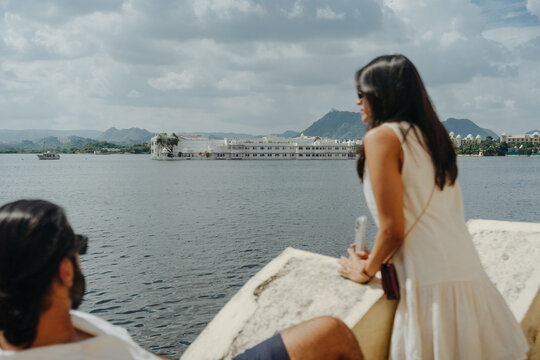 Couple Relaxing by the Lake While Admiring the Scenic View