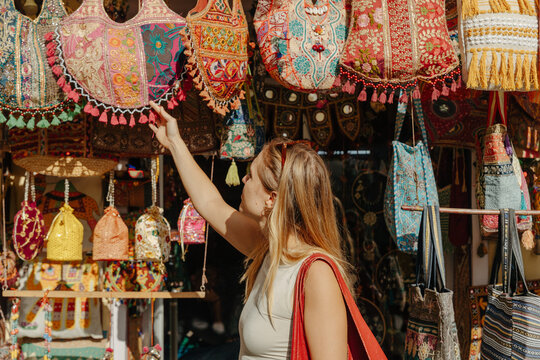 Exploring Colorful Bags at a Vibrant Market in the Afternoon Sun