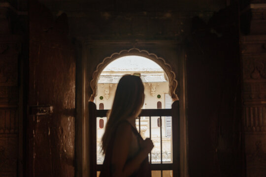 Silhouette of a Woman Looking out From an Ancient Doorway at Sunset