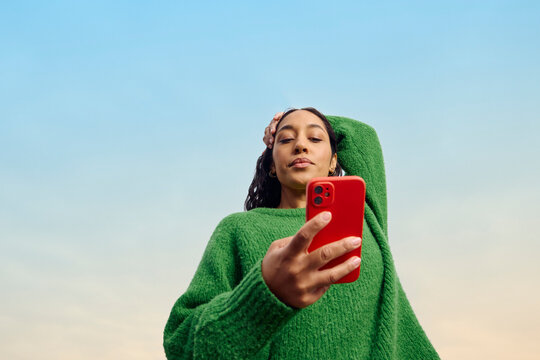 Casual woman looks at her phone