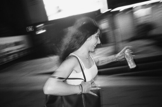 Young brunette smiling running in the street