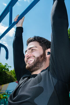 Man Enjoying Outdoor Exercise on a Sunny Day at a Playground