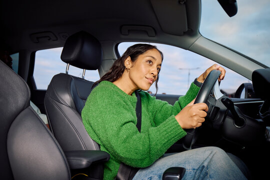 Woman drives a car in the city