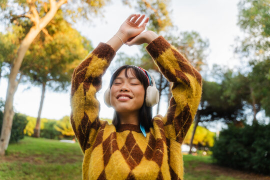 Happy woman enjoys music