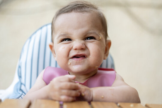 Baby With Food On Face Making Expression