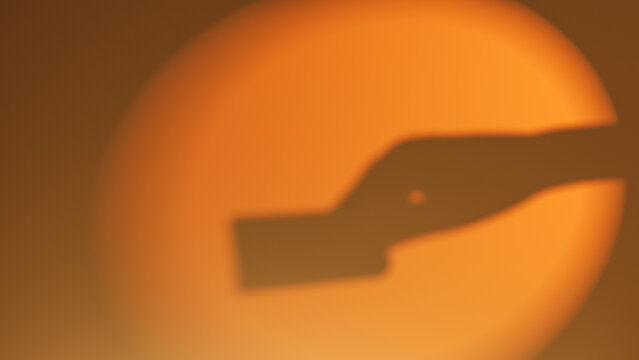 Hand holding a card in front of warm sunset background