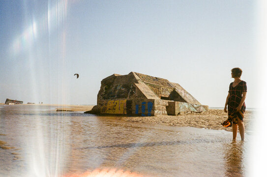 Person looking at a bunker in french Atlantic ocean beach