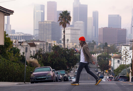 Man walking street Los Angeles skyline 