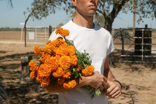 Man Bringing Marigold Flowers to Cemetery