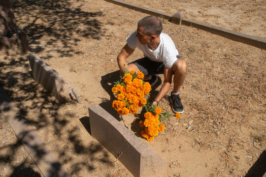 Man Leaving Flowers in Cemetery