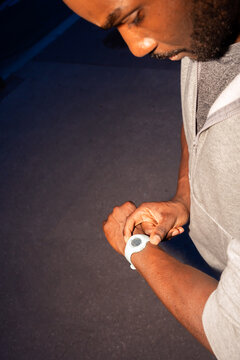 Man Checking Fitness Watch During Evening Workout in the Park