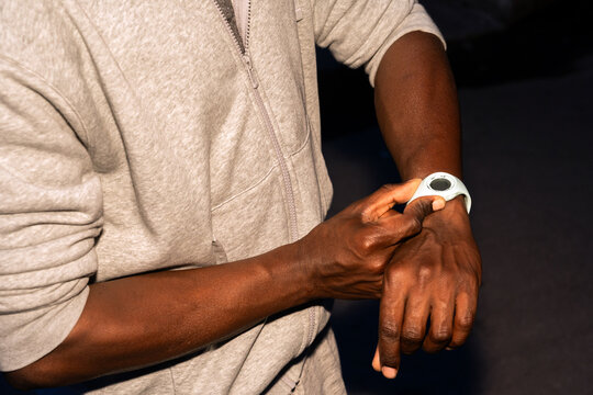 Man Checking Smartwatch in Casual Clothing Indoors