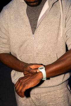 Checking Fitness Tracker During Evening Workout Session