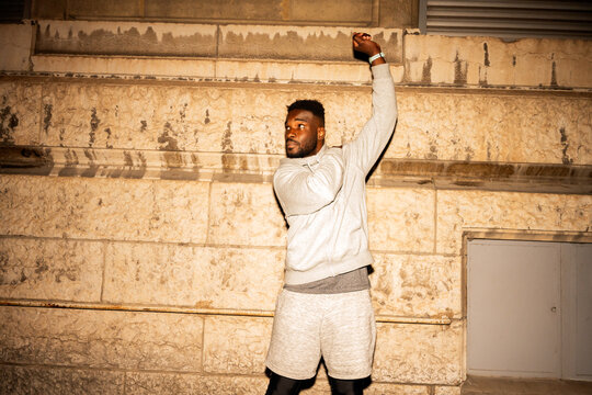 Man Practicing Sport Moves in Urban Setting at Night