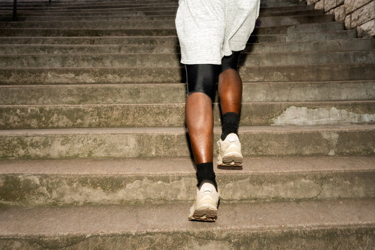Man Ascending Concrete Stairs During Training Session