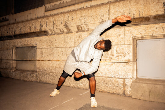 Stretching in the City at Night for Fitness and Health