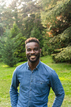 Smiling Man Enjoying Nature in a Green Park Setting