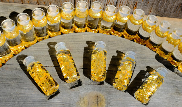 Genuine Lapland gold flakes in miniature glass vials representing precious metal investment and physical commodity assets. 
