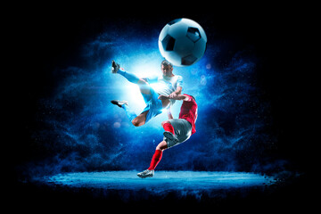 Obraz premium Soccer. Soccer players on a beautiful black background with a flash of light behind them. Isolated on a black background. Sports