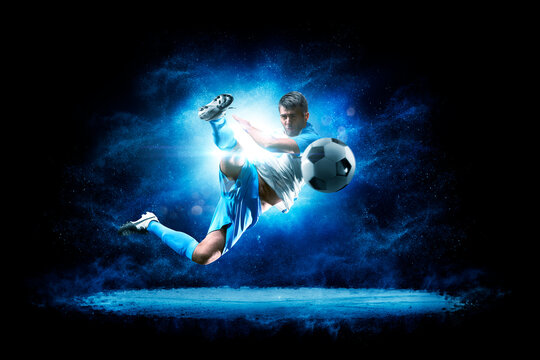 Soccer. Soccer players on a beautiful black background with a flash of light behind them. Isolated on a black background. Sports