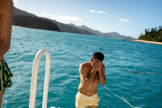 Man swimming in turquoise sea hamilton island
